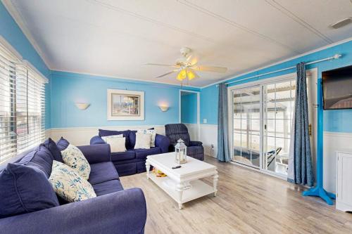a blue living room with a couch and a table at Oyster Lane Hideout in Ocean City
