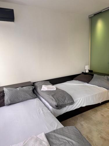 two beds sitting in a room with a wall at Апартамент 310 in Primorsko