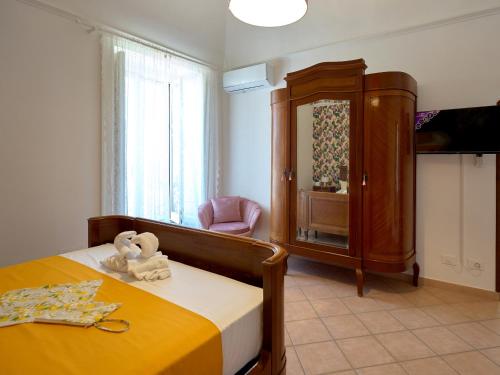 a bedroom with a bed and a cabinet and a chair at The Lemon Garden Escape in Meta