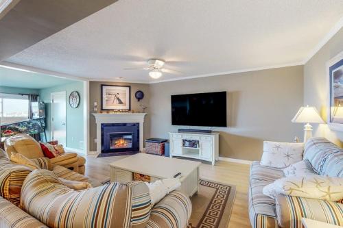 a living room with two couches and a fireplace at Our Place At The Beach 206B in Ocean City