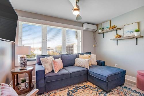 a living room with a blue couch and a window at Boho Bayshore 42 in Ocean City