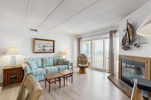 a living room with a couch and a fireplace at Purnell House 402 in Ocean City