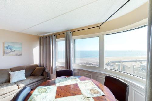 a living room with a table and a couch at Atlantis 502 in Ocean City