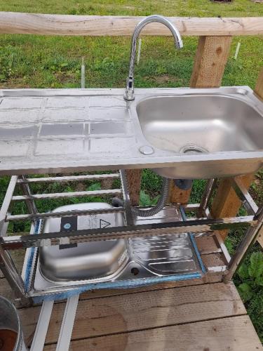 a sink with a faucet on top of a table at Glamping Bell Tent in Norton Saint Philip