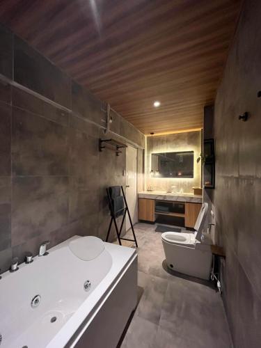a bathroom with a tub and a toilet and a sink at CHL Pod in General Trias