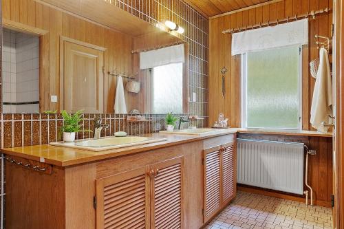 a bathroom with two sinks and a large mirror at Spacious Villa near Gothenburg in Alingsås