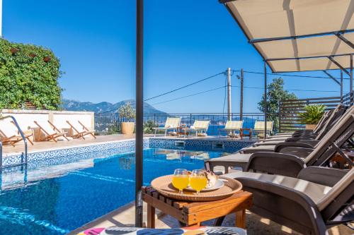 a patio with a table with two glasses of orange juice at Apartments Oktopus in Sutomore