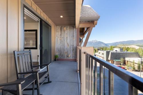 a balcony with a rocking chair on a house at Sail Lofts #301 in Dillon