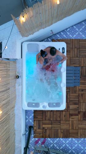 a picture of a person in a swimming pool at Zisa Top Romantic Terrace & Private outdoor Jacuzzi in Palermo