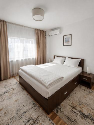 a bedroom with a large bed and a window at Adrian Home Mega in Ploieşti