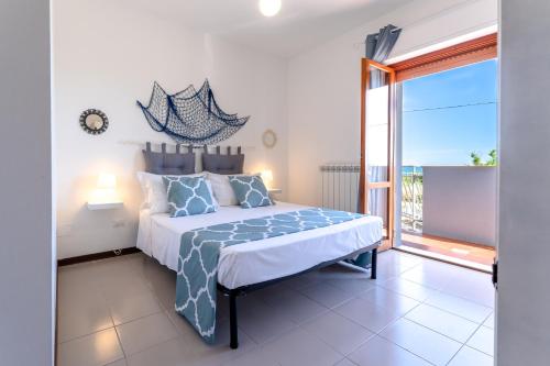 a bedroom with a bed and a large window at Altea in Fossacesia