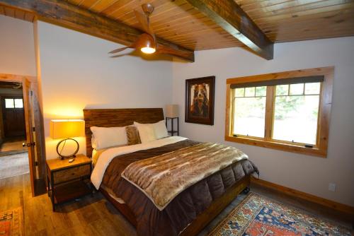 a bedroom with a bed and a ceiling fan at Deer Lodge #2- Lake Front in Bass Lake