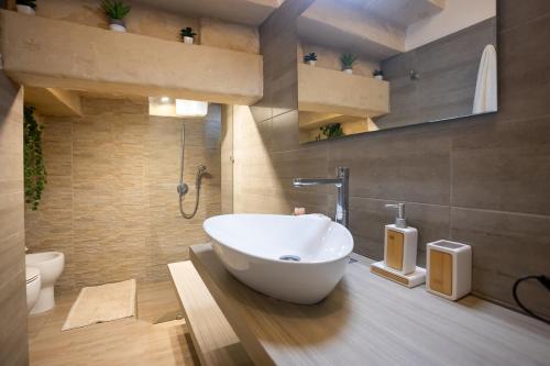 a bathroom with a tub and a sink in it at Il rifugio barocco in Lecce