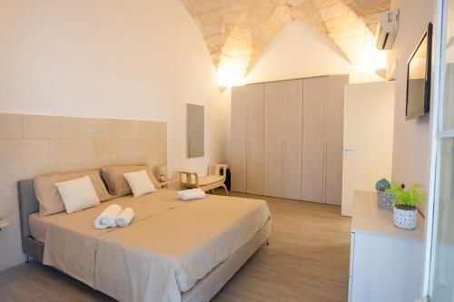 a bedroom with a large bed with two towels on it at Il rifugio barocco in Lecce