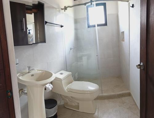 a bathroom with a toilet and a sink and a shower at El Eden in Sáchica