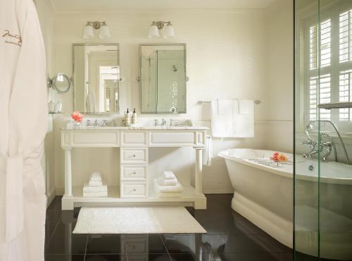 a white bathroom with a tub and a sink at Montage Palmetto Bluff in Bluffton