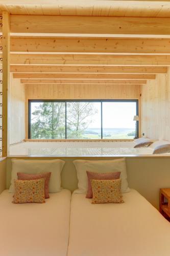 a large white couch in a room with a window at Le Chalet Cormoyeux in Cormoyeux