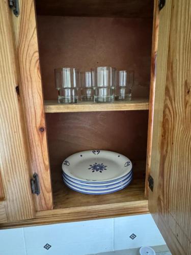a wooden cabinet with a plate and dishes in it at Katty House in Santa Bárbara de Samaná