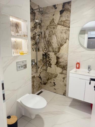 a bathroom with a toilet and a sink at RICH 2 Apartment in Plovdiv