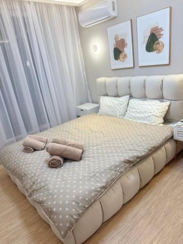 a bedroom with a large bed with two towels on it at RICH 2 Apartment in Plovdiv