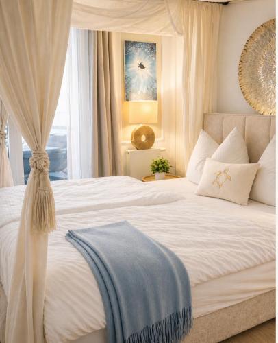 a bedroom with a large white bed with a window at PEARL COAST Luxury Rogowo Pool Beach in Rogowo