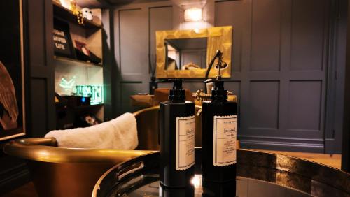 Zwei Flaschen Wein stehen auf einer Theke in einer Bar. in der Unterkunft Black Rabbit Croston Boutique Hotel & Restaurant in Croston