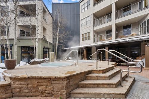 a hot tub in a courtyard in front of a building at Silver Mill #8274 in Keystone