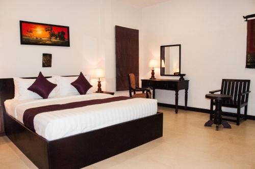 a bedroom with a bed and a desk and a mirror at Private Boutique Home with Pool, The Fin Angkor Boutique in Siem Reap