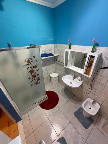 a bathroom with a toilet and a sink at B&B JOY in Nettuno