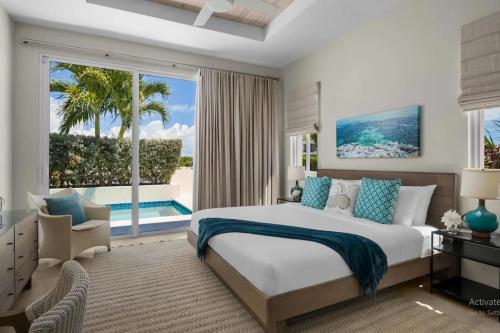a bedroom with a large bed and a large window at Second Wind Villa in Long Bay Hills