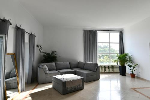 a living room with a couch and a window at Casa do Sol Wellness Villa in Óbidos