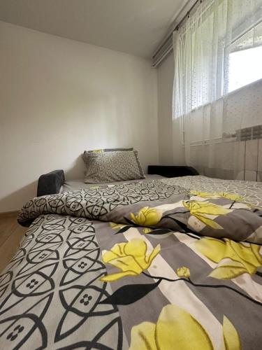 a bedroom with a bed with a blanket on it at Orkana44F in Mszana Dolna