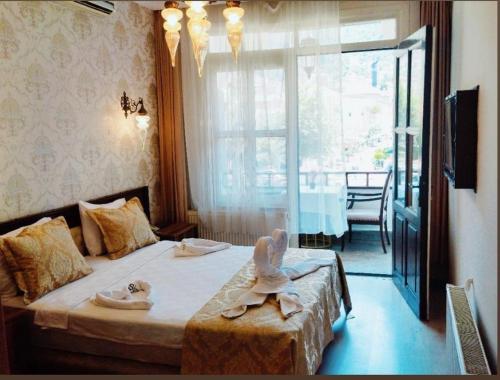 a hotel room with a bed with shoes on it at Şirince otel in Amasya