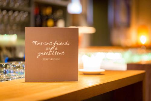 a sign sitting on top of a wooden table at Hotel Seehof in Zell am See