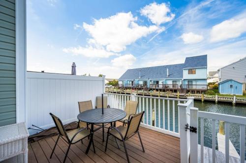 a patio with a table and chairs on a balcony at Nassau Village 24 in Ocean City
