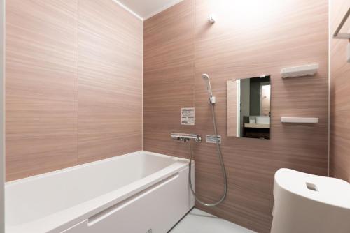 a bathroom with a bath tub and a sink at HOTEL PG3 - Vacation STAY 46442v in Habu