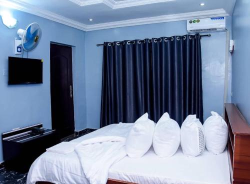 a bedroom with a bed with white pillows on it at Luxury Deluxe 1 Bed, 1 Bath in Otta