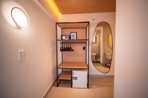 a room with a mirror and a shelf with knives at Oklahoma Inn in Foz do Iguaçu