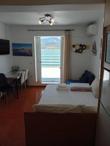 a bedroom with a bed and a view of the ocean at Demetrius's Penthouse in Chalkida
