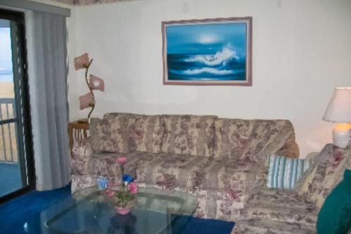 a living room with a couch and a glass table at Bay Princess 103 in Ocean City