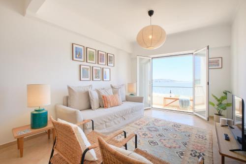 a living room with a couch and a view of the ocean at Dreamy Sea View Balcony in Algés