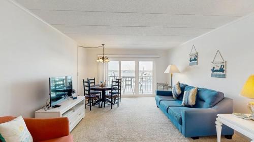 a living room with a blue couch and a television at White Marlin 105B in Ocean City