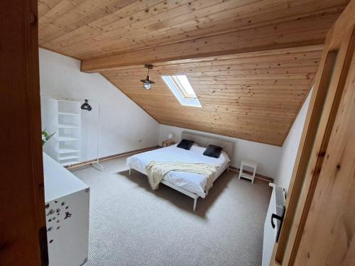 a bedroom with a bed and a wooden ceiling at Casa Noastra in Drajna de Sus