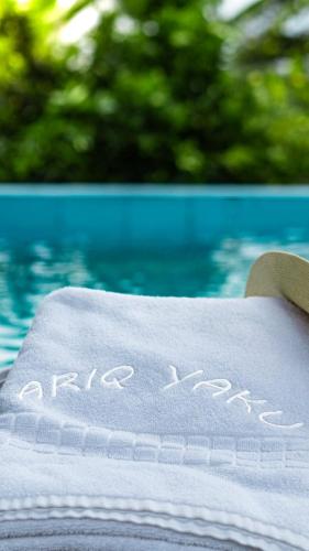 a towel that says happy anniversary sitting next to a pool at Hostería en Chachimbiro - Ariq in Hacienda San Francisco