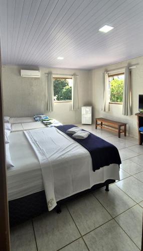 a large bedroom with a large bed in it at Pousada chafariz in Pirenópolis