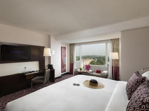 a hotel room with a bed with a hat on it at Novotel Yangon Max in Yangon