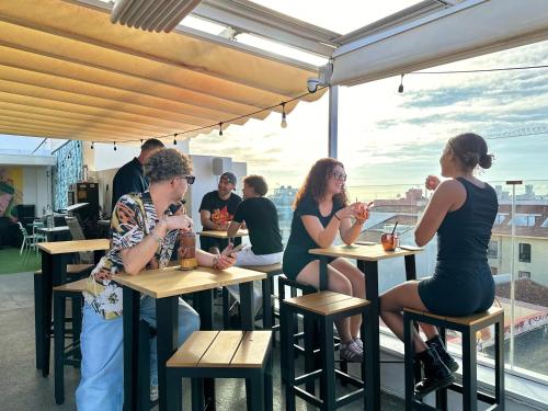 a group of women sitting at tables in a restaurant at Atypicap Capsule Hostel in Puerto de la Cruz