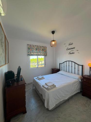a bedroom with a bed and a window at BLUE Dreams in Mijas Costa