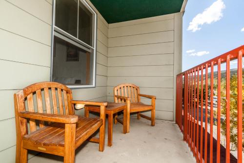 two wooden chairs sitting on the porch of a house at Silver Mill #8222 in Keystone