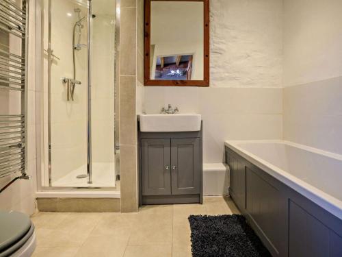 a bathroom with a sink and a tub and a shower at 1 Bed in Taunton oc-87929 in Pitminster